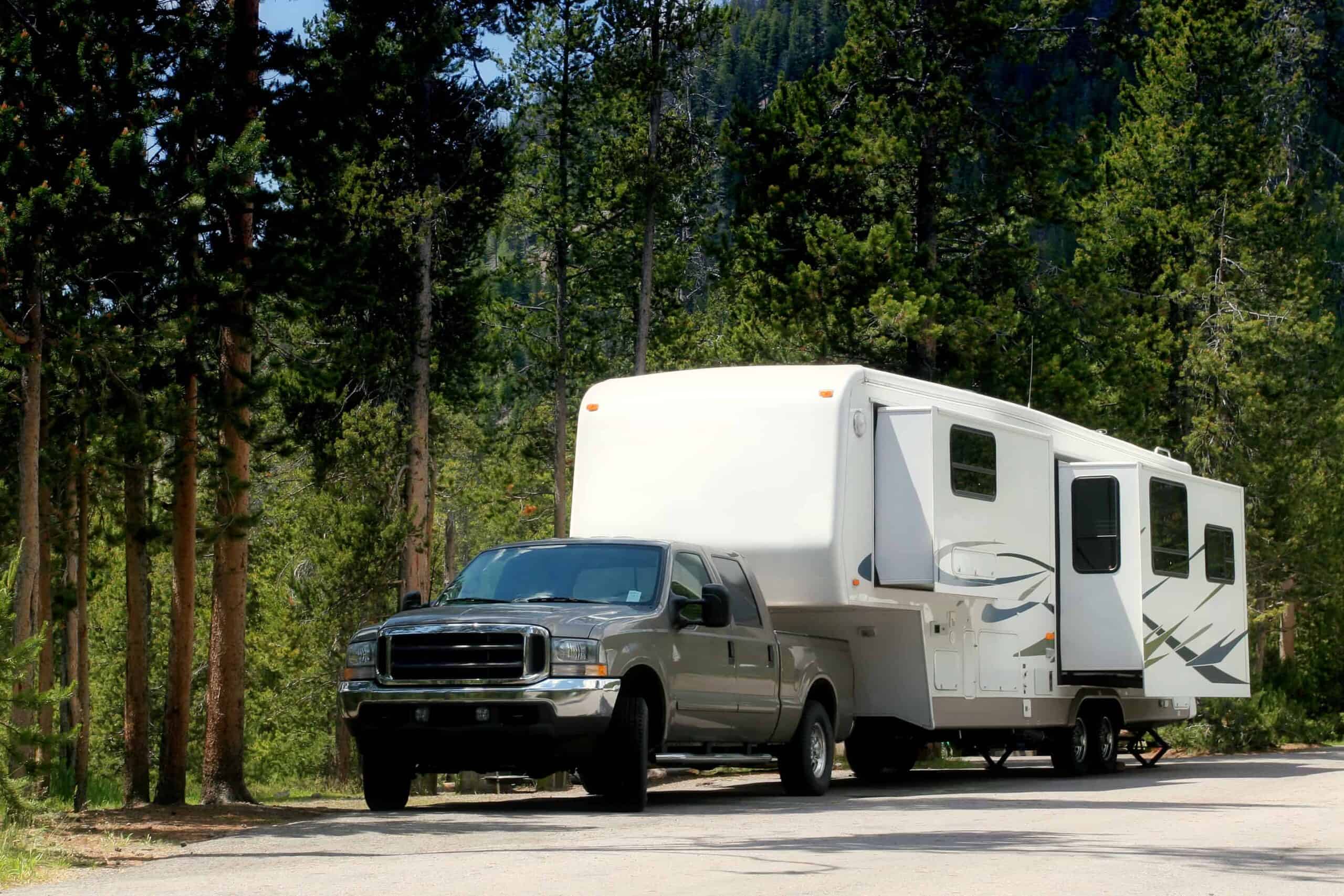 pickup truck towing a fifth wheel trailer with a gooseneck hitch